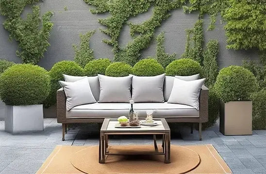 Outdoor pillows on a patio set with greenery, showcasing their durability and comfort.